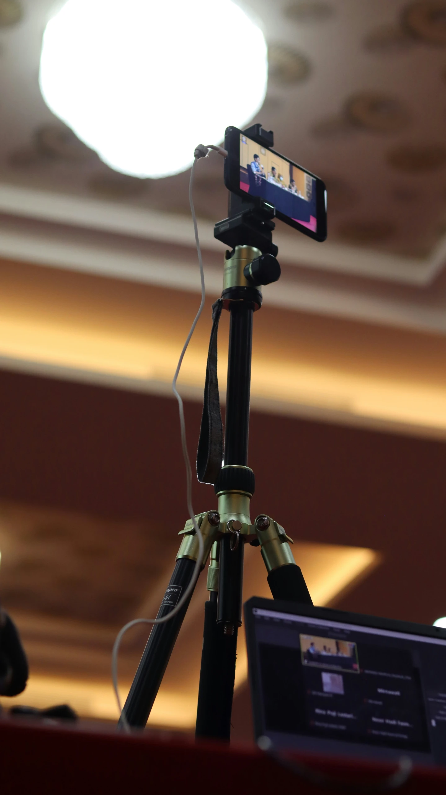 a camera attached to a tripod with other items
