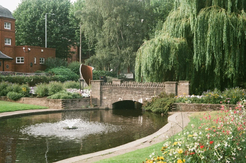 the small bridge has lots of flowers by it