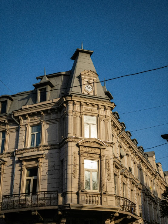 a clock is hanging outside a big building