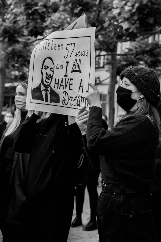 black and white pograph of protesters holding sign