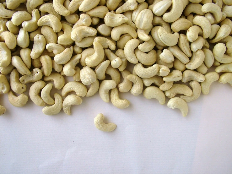 peeled nuts are being tossed into a pile