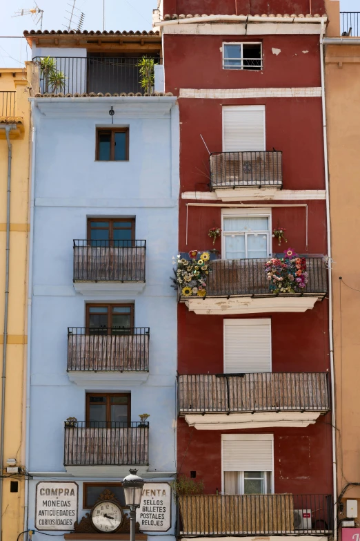 a blue building with some red and yellow buildings