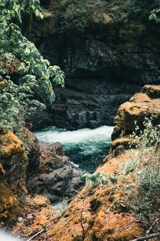 a po of water flowing between some rocks