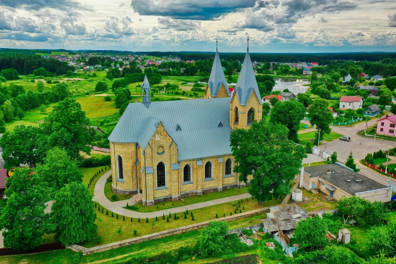 a church in a city surrounded by lush green trees