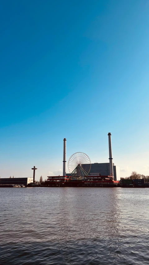 a picture taken from the water of an industrial dock