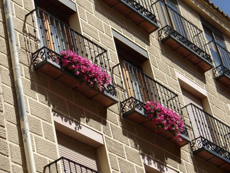 a building with balconies and flower boxes on the balcony