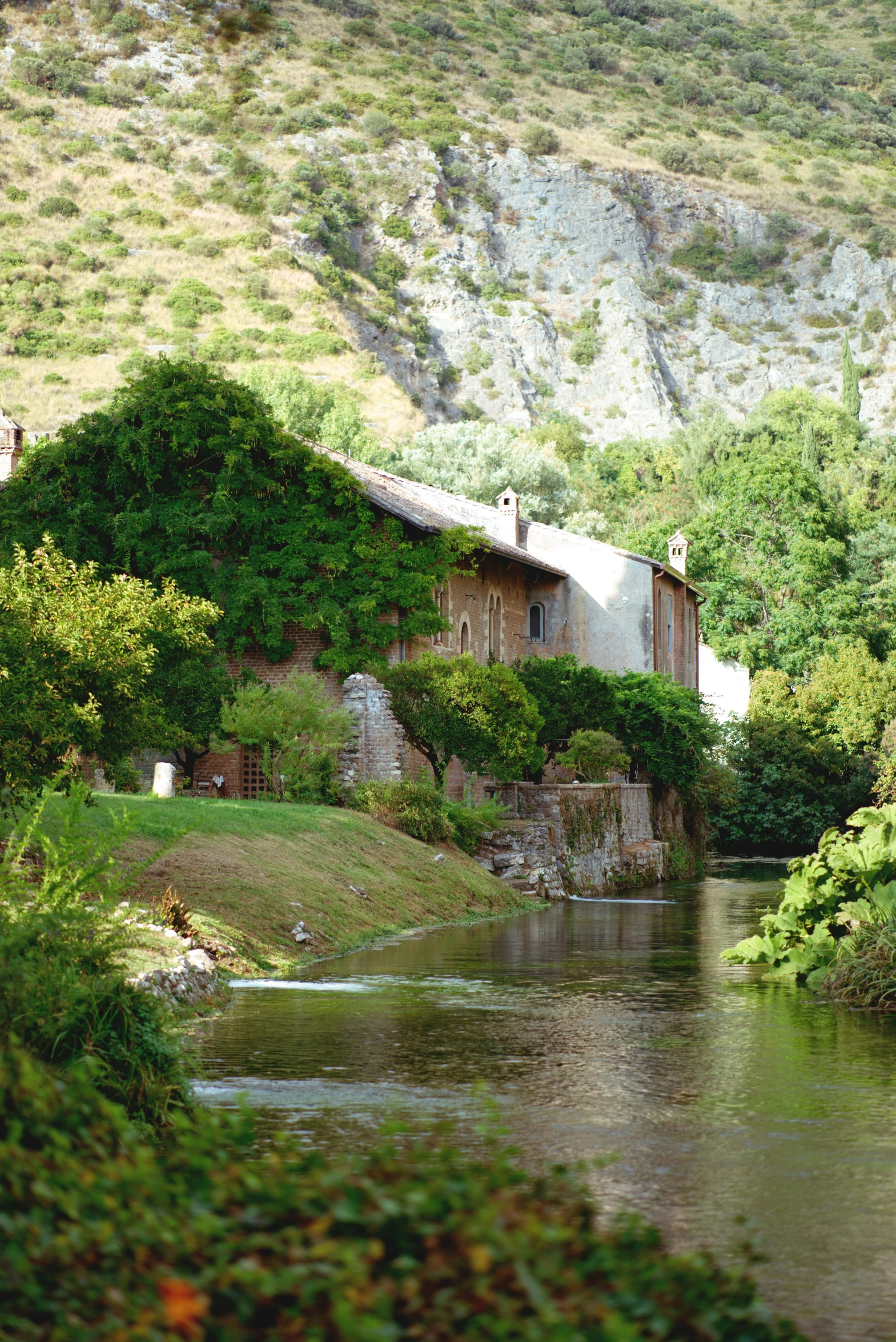 an old building on the side of a river