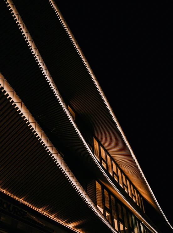 the top of a building at night with lots of lights