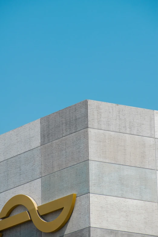 a large golden bird standing on the top of the wall