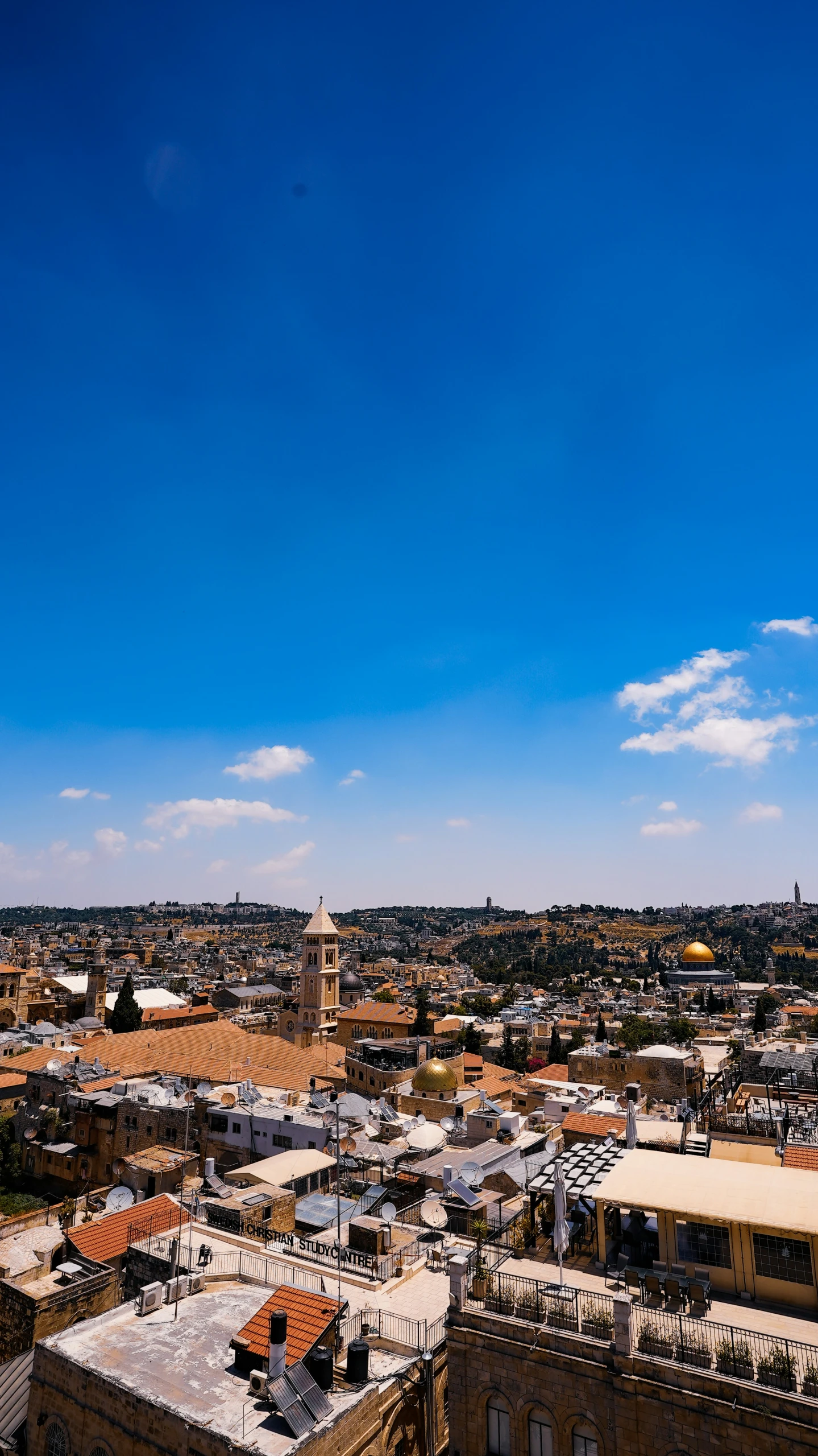 city buildings, and a blue sky with white clouds