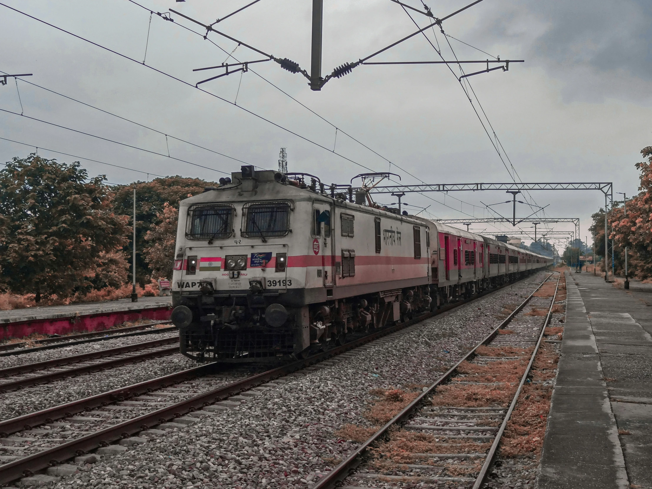 a train traveling on tracks next to a rural setting