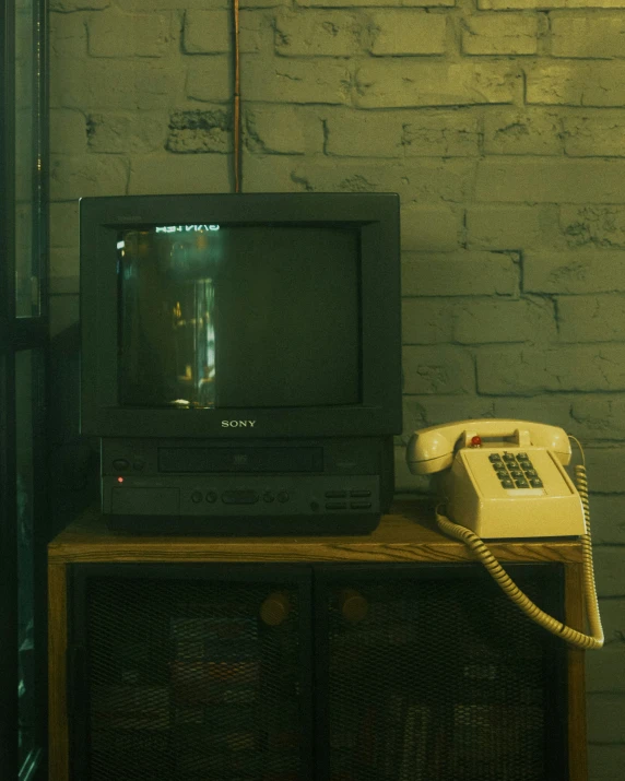 a cell phone, tv and television sitting on a table