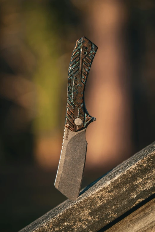 a knife resting on top of a wooden bench