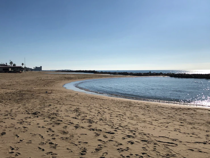 footprints on the sandy beach near the ocean