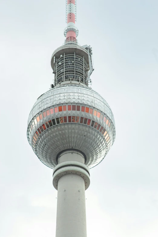 a tall tower with a white and pink top