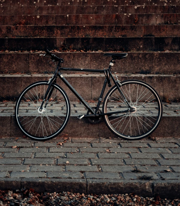 a bicycle is parked against a brick step