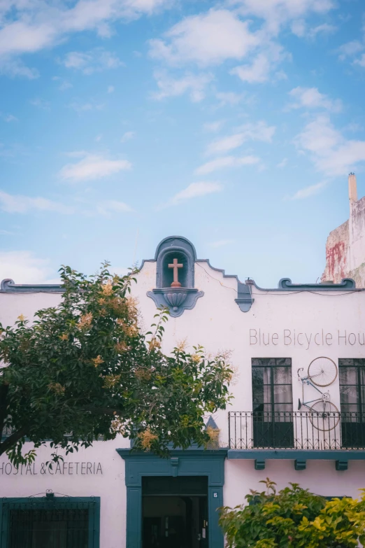 the building with a cross on it's side is painted white