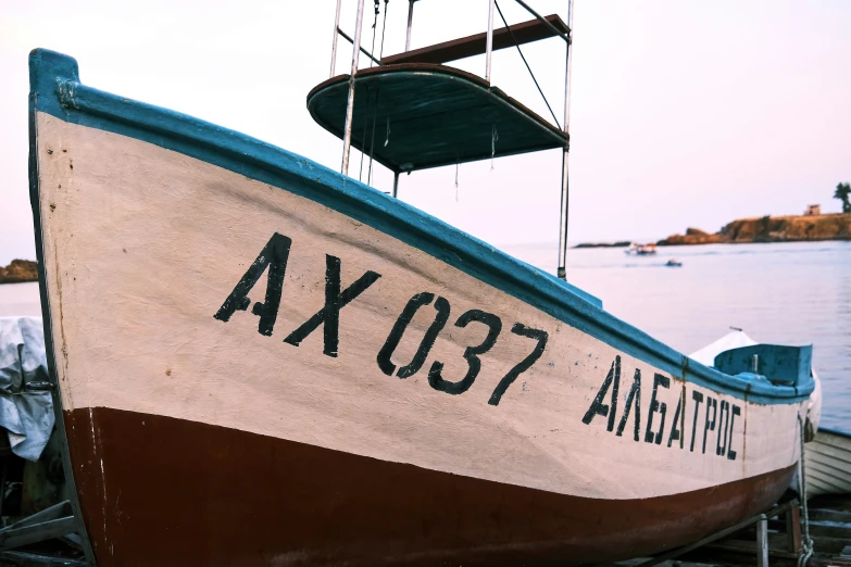 a large boat is docked on the shore near water