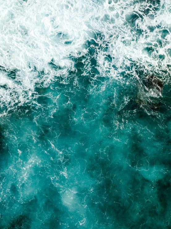 a wave is rolling in on the ocean surface