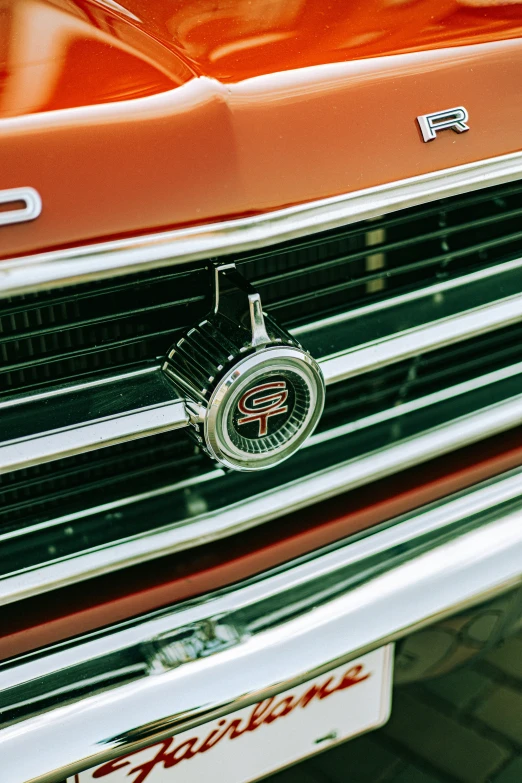 a red classic muscle truck's grille emblem is pictured