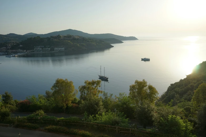 the sun shines brightly over the water of an island