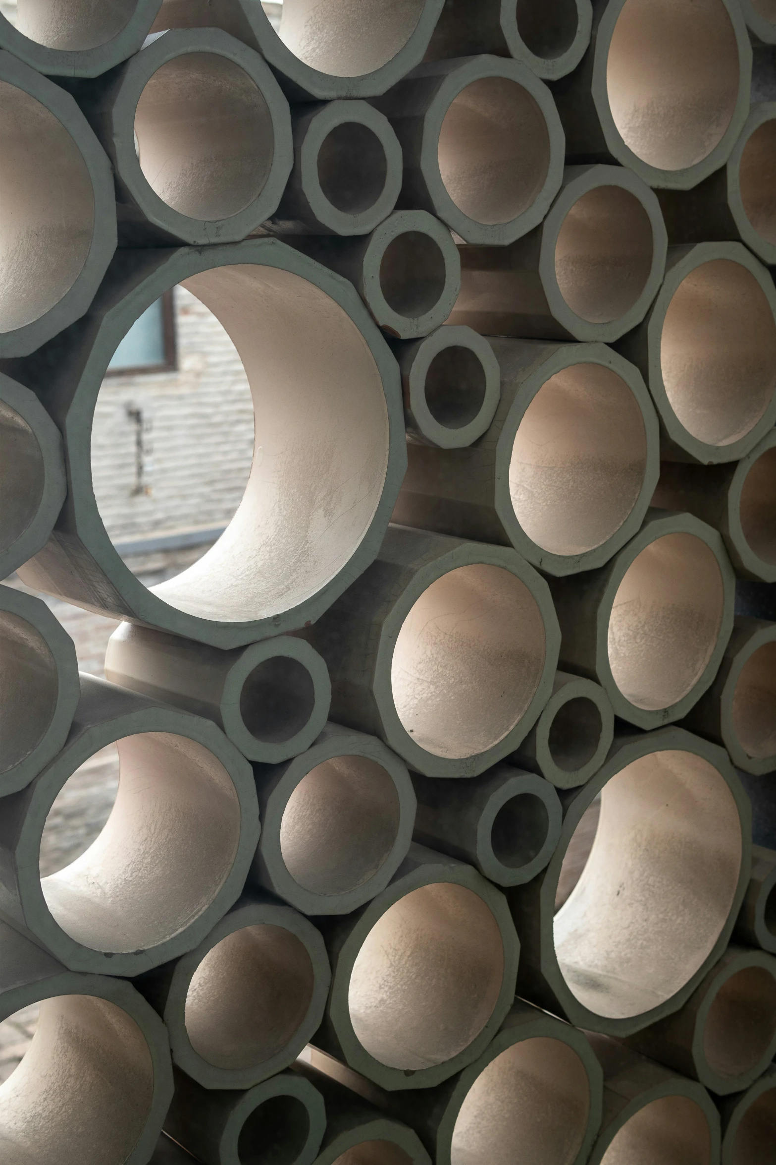 a pile of concrete pipes stacked together in front of each other