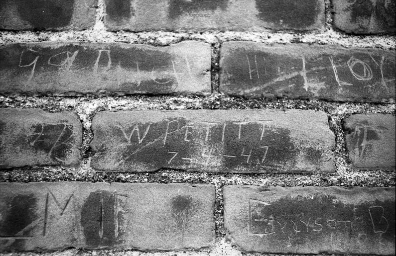 a brick wall is shown with writing on it