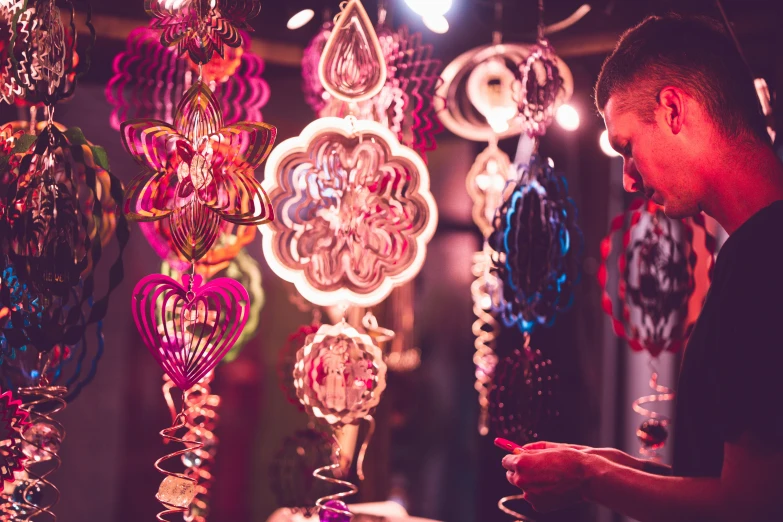 a person standing in front of a group of jewelry