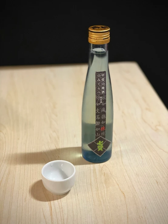 an empty container sitting next to a small bowl on a table