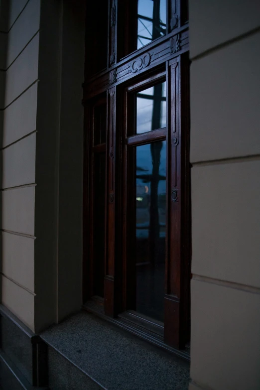 the dark corner of a house with a wooden door