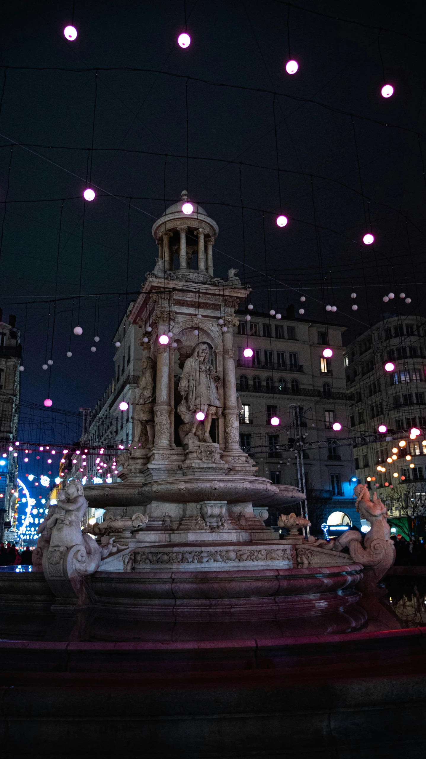 the fountain is illuminated in bright colored lights