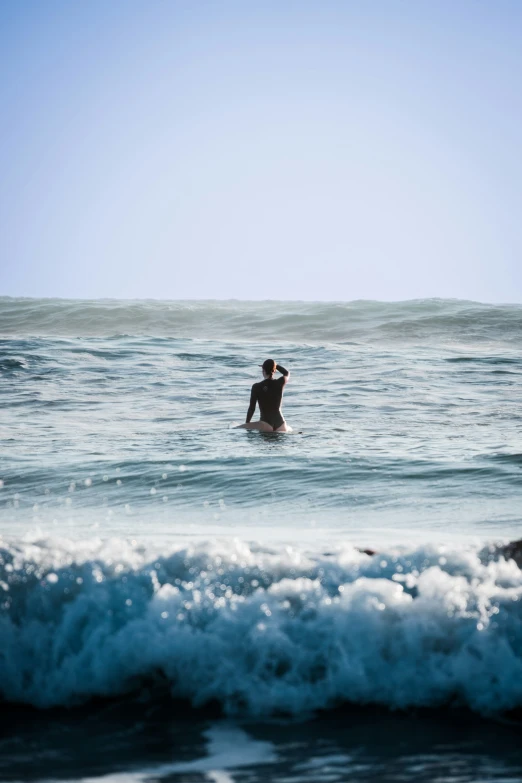 a person on a surfboard standing in the water