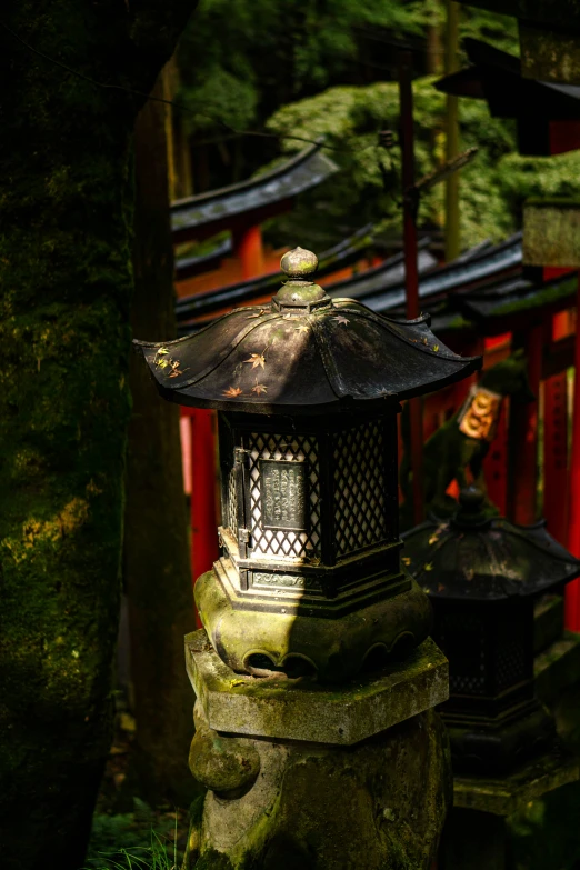 the lantern lights on the table next to some rocks