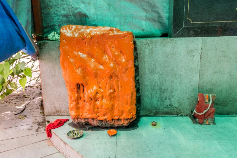 a red piece of wood and some shoes on the ground