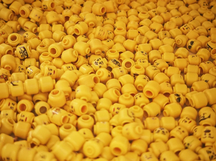 a bunch of yellow plastic beads is stacked