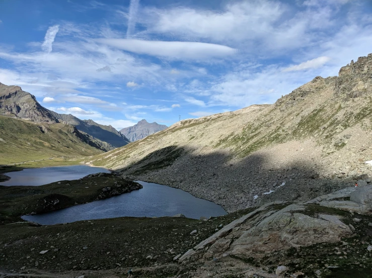 some mountains water and a sky with clouds