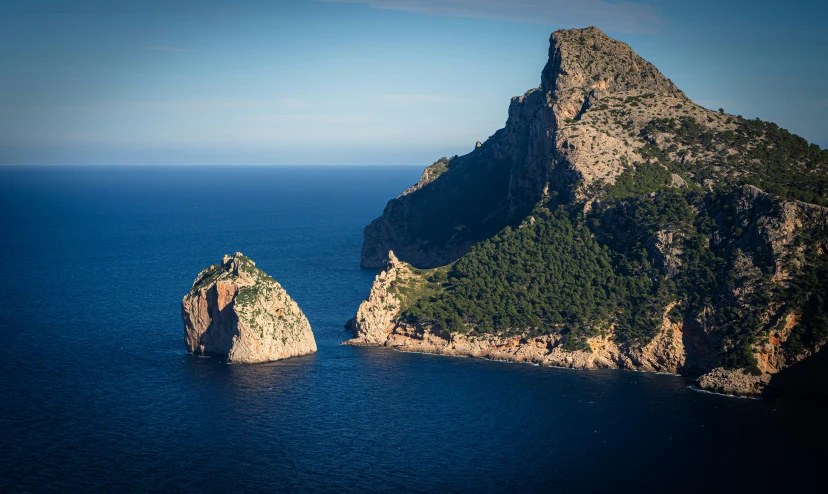 a rock in the middle of a body of water