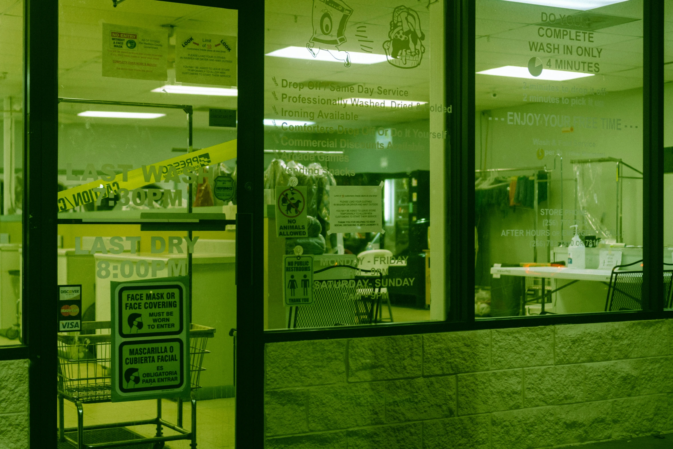 an open business window with signs and tables in it