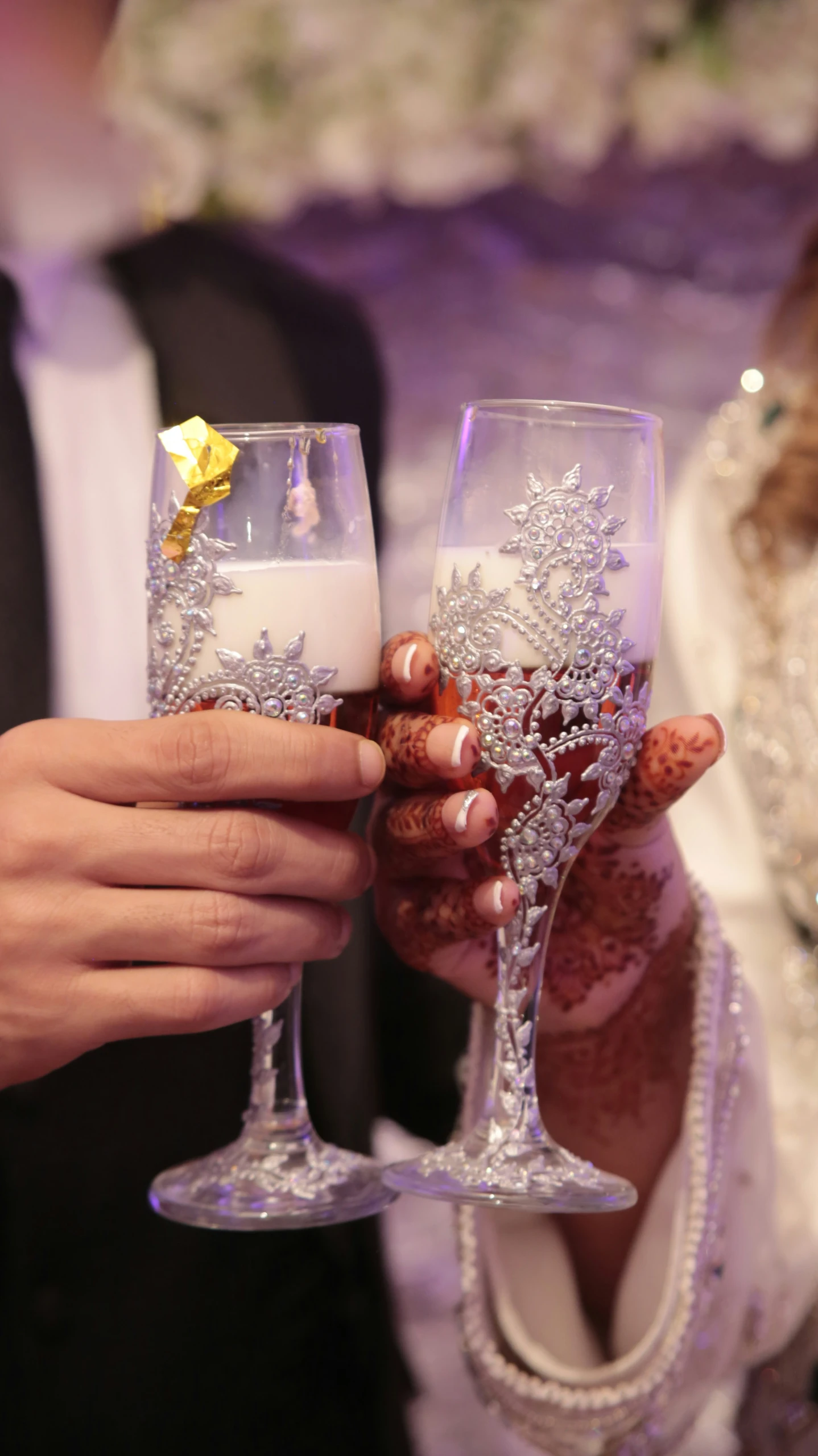 the bride holding her champagne glass with an iced icey wedding cake on top