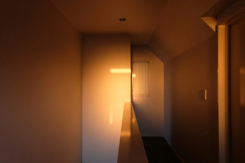 the light is shining on an empty hallway