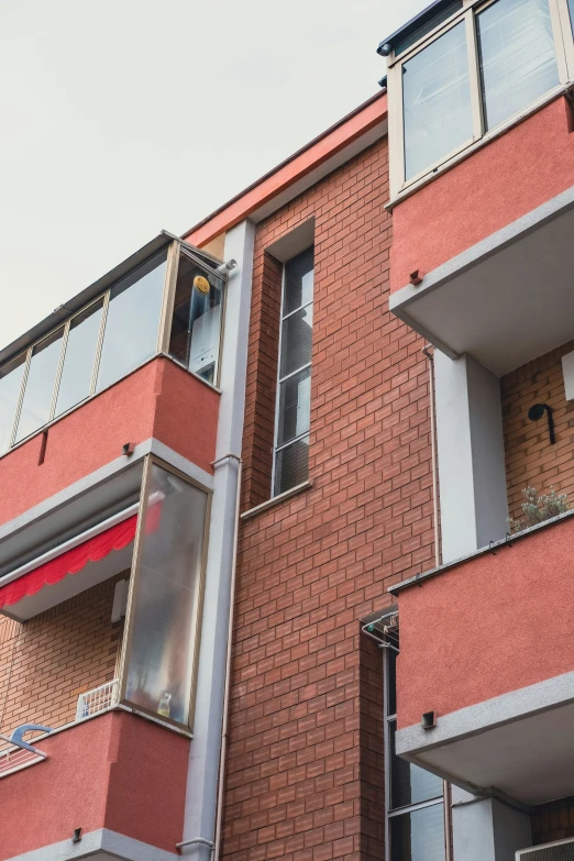 a brick building with lots of windows and a sign posted above the window