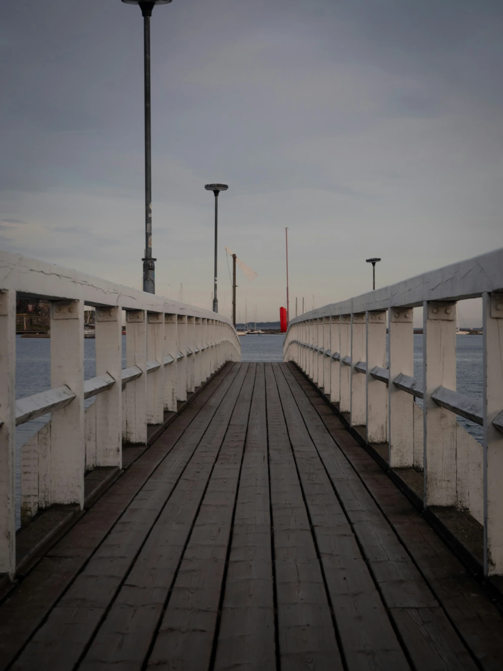 empty bridge with some lights in the distance