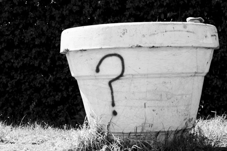 black and white pograph of a cement bucket with graffiti