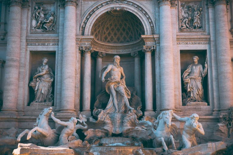 sculptures surround a fountain in a stone building