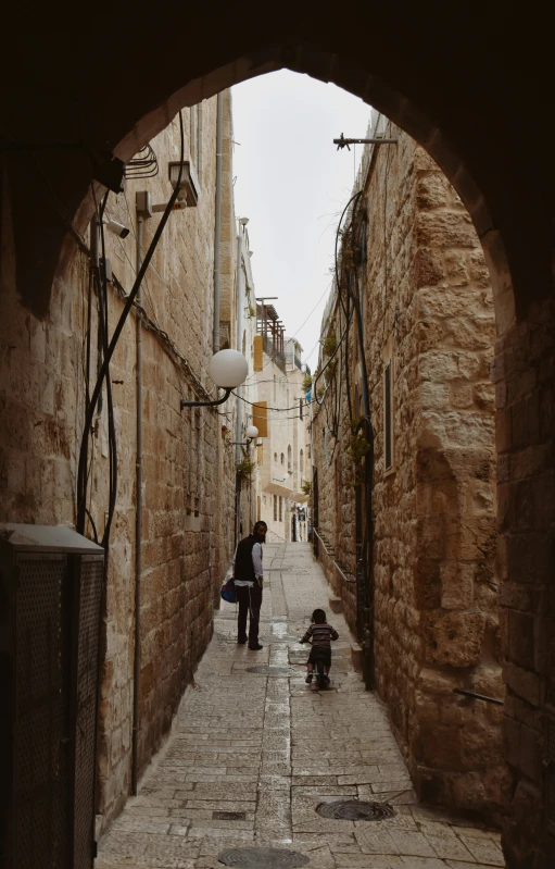 an archway that leads to a street leading to a building