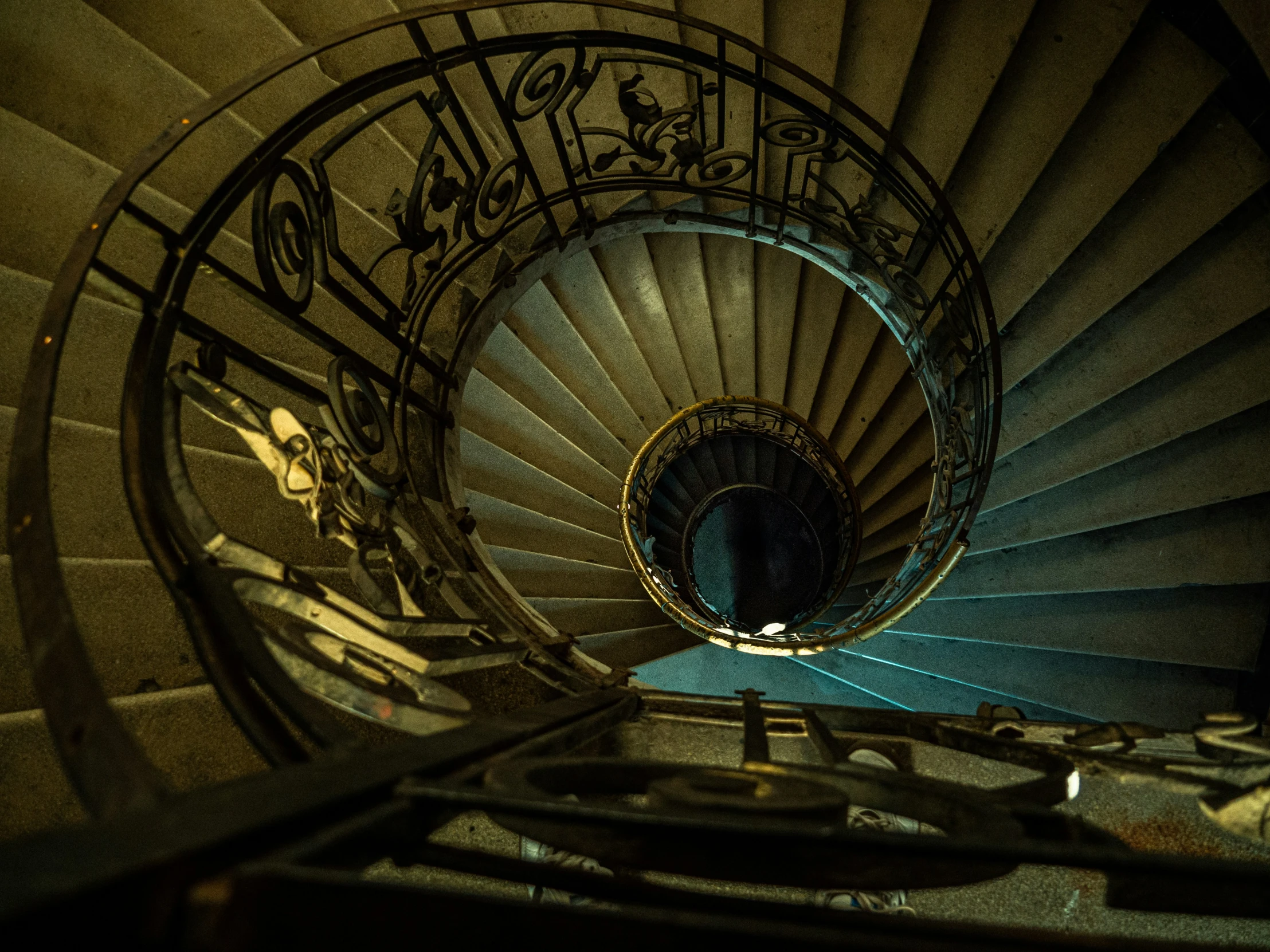 a view looking down at a spiral staircase in a building