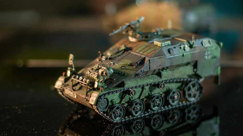 a close up of a toy tank on a surface