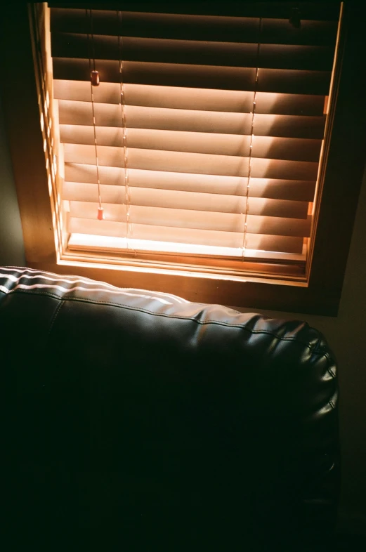 the sun is shining through the blinds of the window