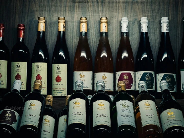 wine bottles and labels are lined up on display