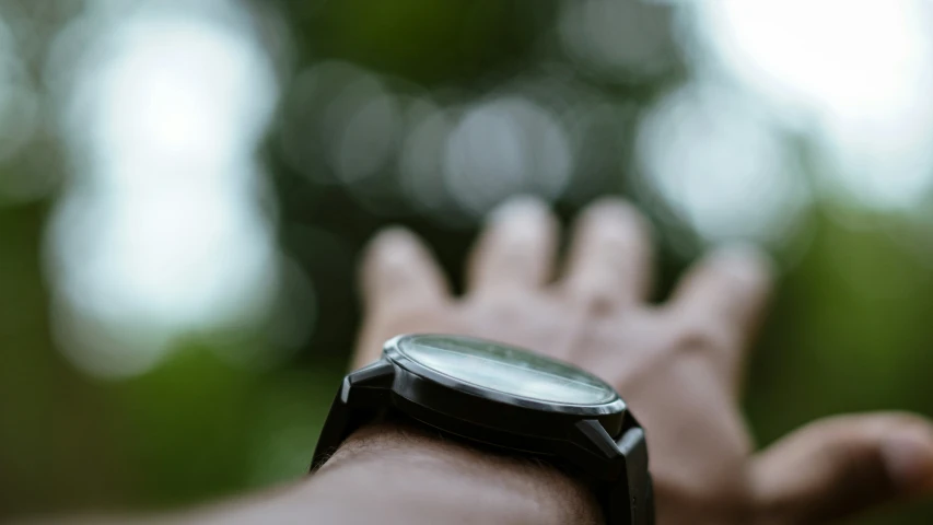 a black watch being held in both hands